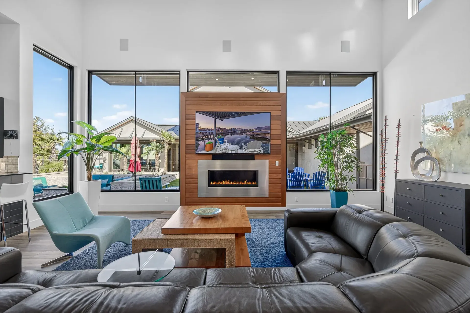 Living room fireplace wall with pool views